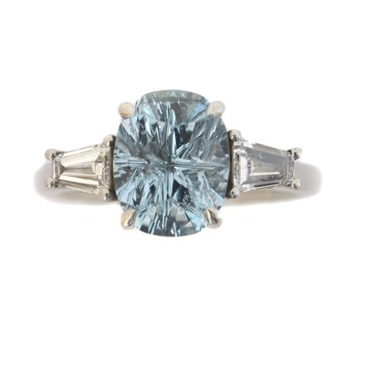 Lot 153 - A platinum aquamarine and diamond three stone ring.