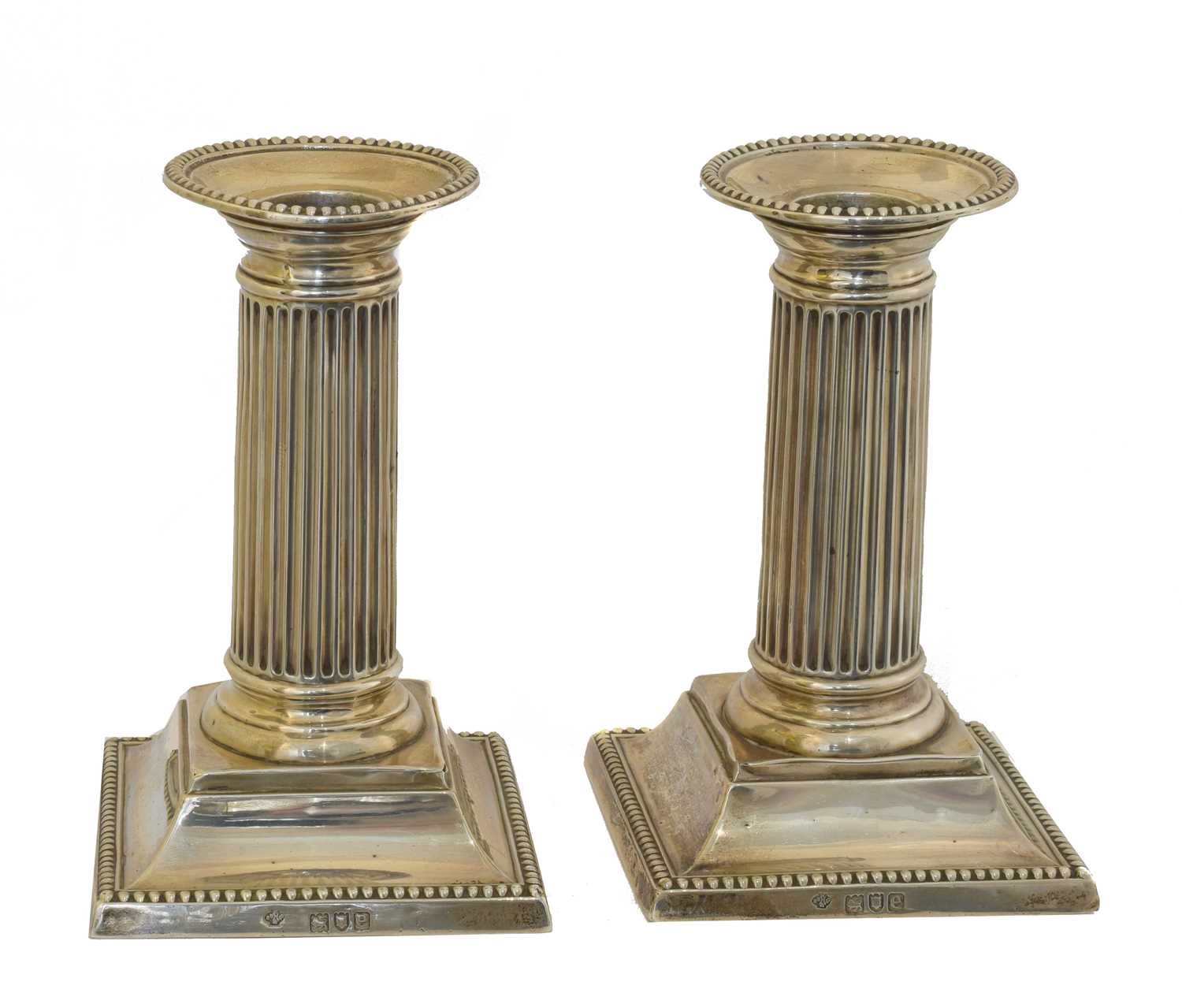 Lot 21 - A pair of Victorian silver candlesticks.