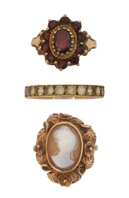 Lot 104 - Three gem-set dress rings.