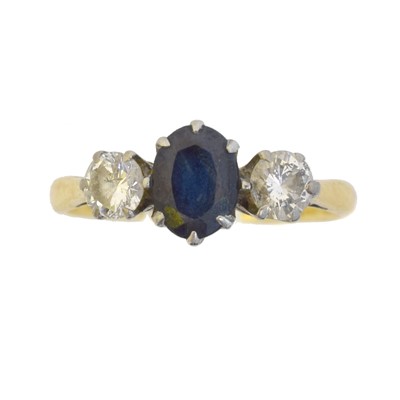 Lot 162 - A sapphire and diamond three stone ring.