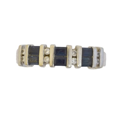 Lot 75 - A sapphire and diamond band ring.