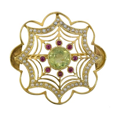 Lot 11 - An early 20th century peridot ruby and split pearl brooch.