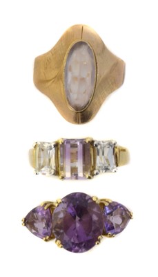 Lot 107 - Three 9ct gold gem-set dress rings.