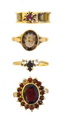 Lot 109 - Four gem-set dress rings.