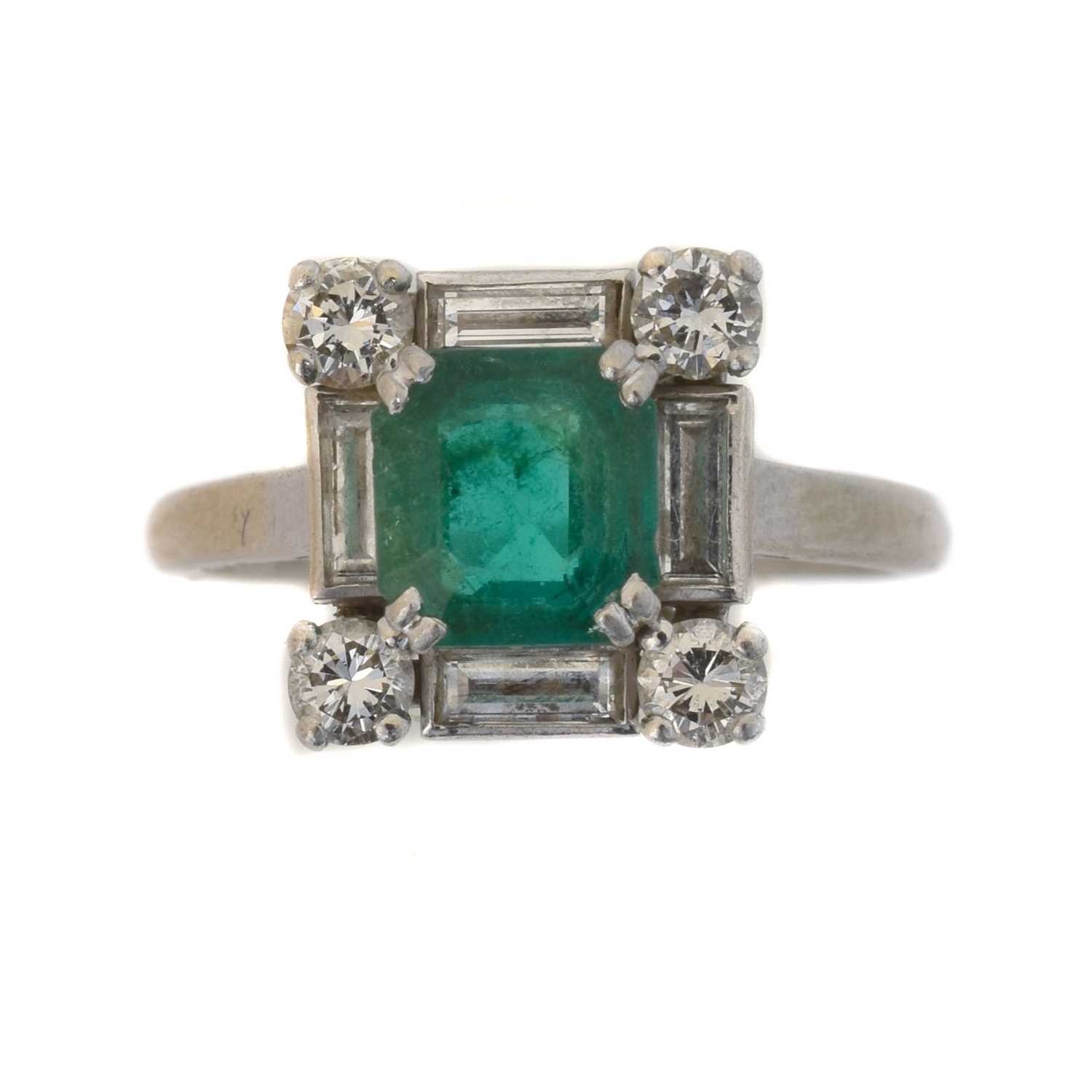 Lot 142 - A platinum emerald and diamond cluster ring by Mauboussin.