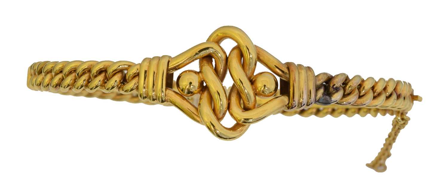 Lot 25 - An early 20th century hinged bangle.