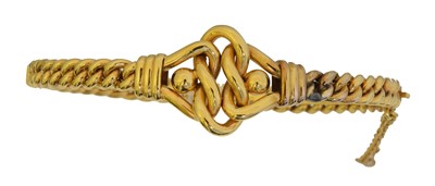 Lot 25 - An early 20th century hinged bangle.