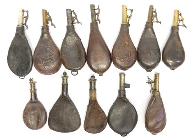 Lot 403 - Twelve leather and brass shot and powder...