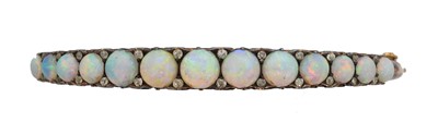 Lot 27 - A Victorian opal and diamond hinged bangle.