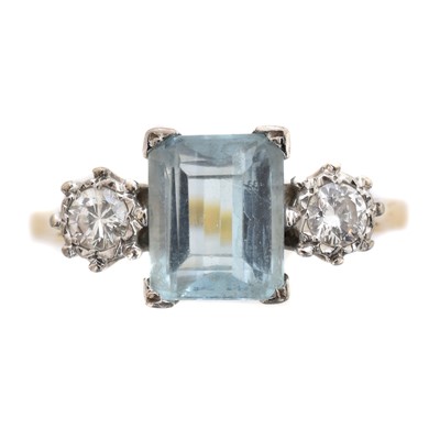 Lot 134 - An aquamarine and diamond three stone ring.