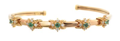 Lot 5 - A 9ct gold emerald and paste bangle.