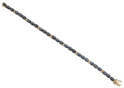 Lot 29 - A sapphire and diamond line bracelet.