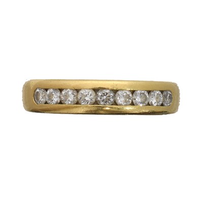 Lot 101 - An 18ct gold diamond band ring.