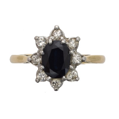 Lot 50 - A sapphire and diamond cluster ring.