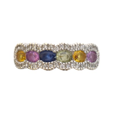 Lot 125 - A sapphire and diamond band ring.