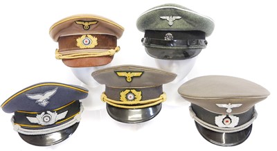 Lot 209 - Five reproduction German Third Reich peaked caps.