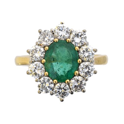 Lot 99 - An 18ct gold emerald and diamond cluster ring.