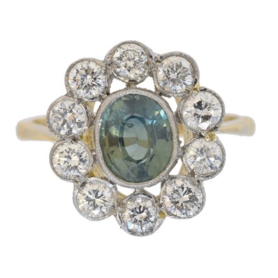 Lot 107 - A sapphire and diamond cluster ring.