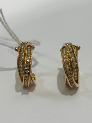 Lot 41 - A pair of 18ct gold diamond 'Trinity' hoop earrings by Cartier.