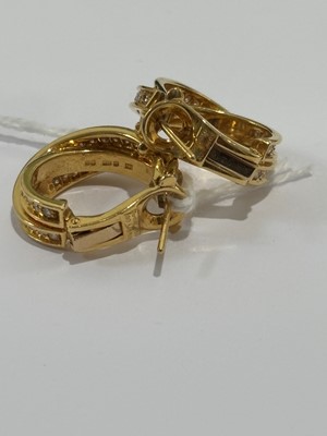 Lot 41 - A pair of 18ct gold diamond 'Trinity' hoop earrings by Cartier.
