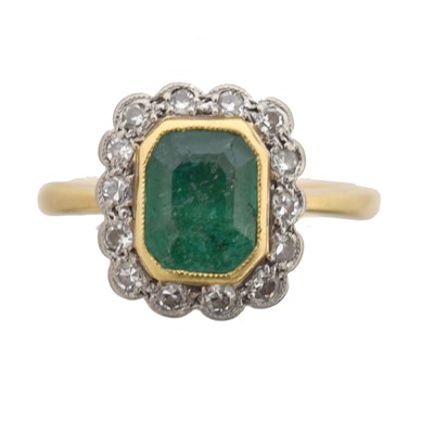 Lot 58 - An emerald and diamond cluster ring.