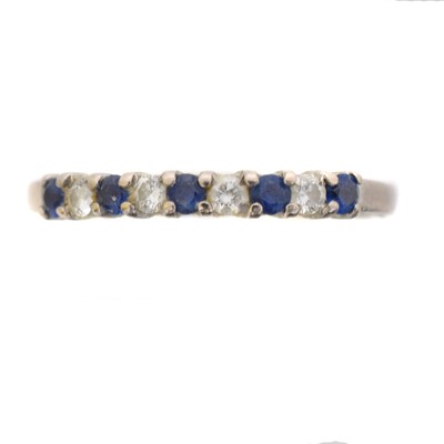 Lot 62 - An 18ct gold sapphire and diamond band ring by Fred Ullman.