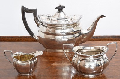 Lot 83 - A silver three piece tea set.
