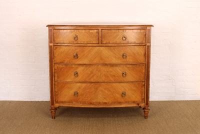 Lot 177 - A Walnut Bowfront Chest of Drawers from the "Spire" Range by Frank Hudson Ltd.