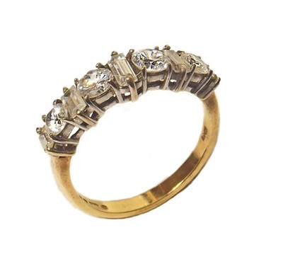 Lot 64 - A 9ct yellow gold cubic zirconia set half hoop ring