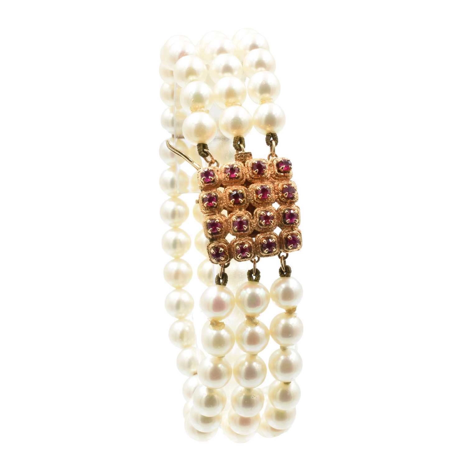 Lot 43 - A 3-row akoya pearl bracelet with a ruby clasp, set in 14ct rose gold