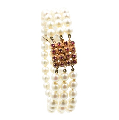 Lot 43 - A 3-row akoya pearl bracelet with a ruby clasp, set in 14ct rose gold