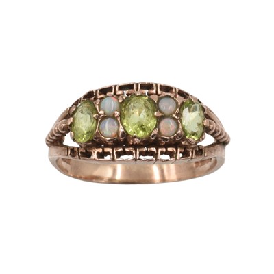 Lot 275 - A peridot and opal boat ring set in 9ct rose gold