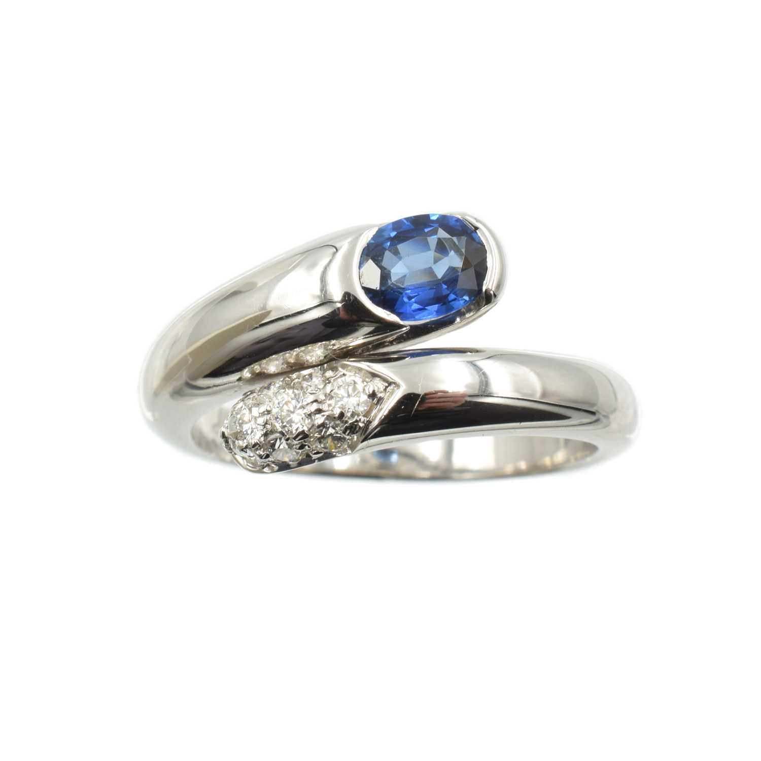 Lot 237 - A sapphire and diamond crossover ring, set in Platinum, by Bulgari