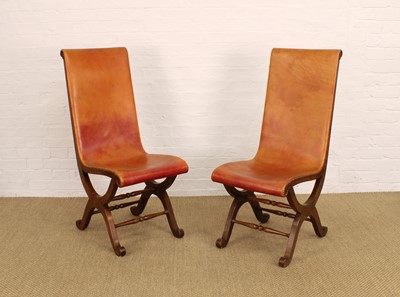 Lot 262 - A Pair of Spanish Oak and Tan Leather 'Slipper' Chairs by Pierre Lottier for Valmazan