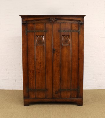 Lot 217 - A Carved Oak Wardrobe in the Arts & Crafts Style by Rackstraw of Worcester