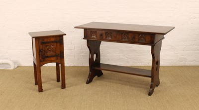 Lot 219 - A Carved Oak Dressing/Side Table and Bedside Cupboard in the Arts & Crafts Style by Rackstraw of Worcester