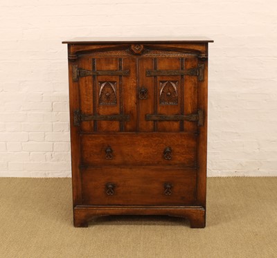 Lot 220 - A Carved Oak Cabinet in the Arts & Crafts Style by Rackstraw of Worcester