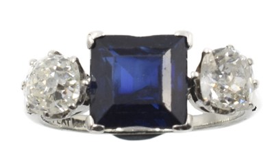 Lot 298 - An octagonal-cut sapphire and diamond 3-stone ring, set in platinum