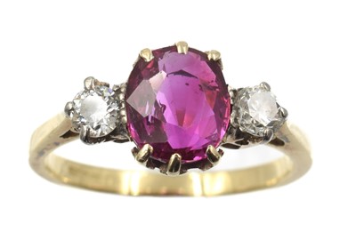 Lot 245 - A ruby and diamond trilogy ring