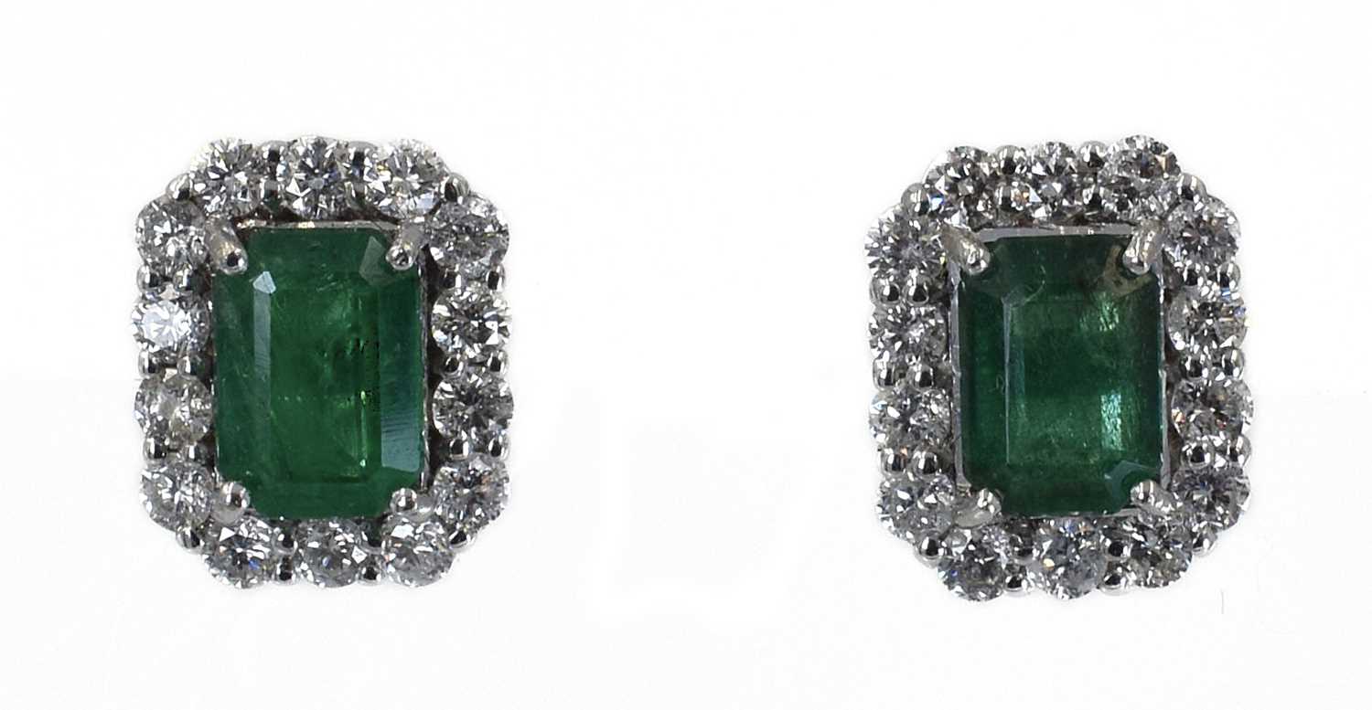 Lot 9 - A pair of 18ct Emerald and Diamond cluster earrings