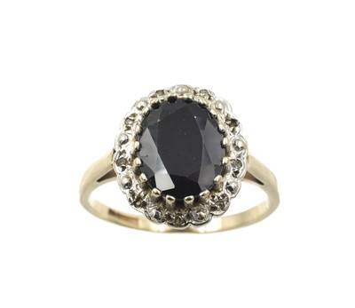 Lot 263 - A sapphire and diamond cluster ring, set in 9ct gold