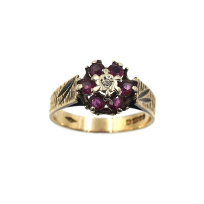 Lot 322 - A ruby and diamond cluster ring, set in 9ct gold