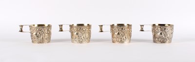 Lot 1 - A Fine Set of Four Edwardian Arts & Crafts Silver 'Cattle' Mugs