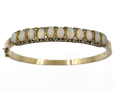 Lot 11 - An opal and diamond bangle, set in 9ct gold
