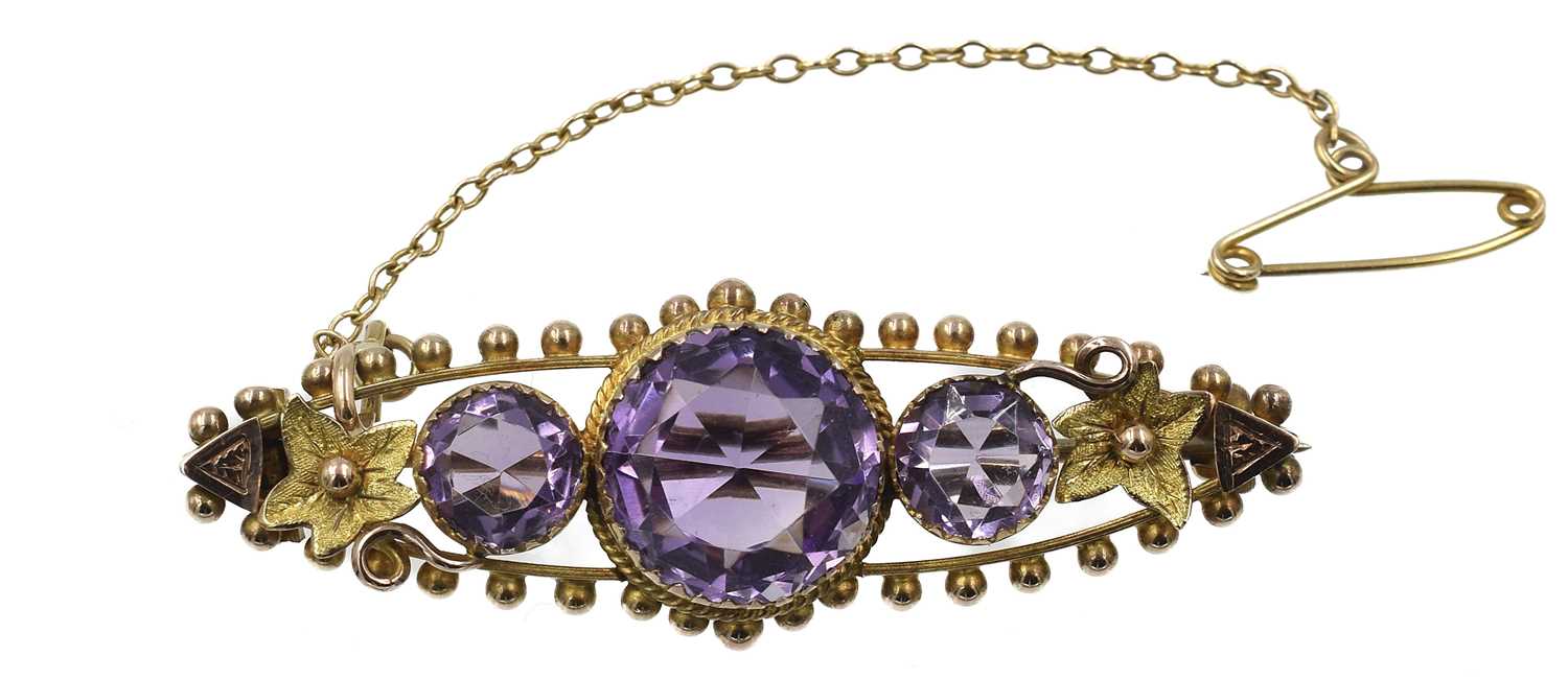 Lot 65 - A 9ct yellow gold amethyst bar brooch