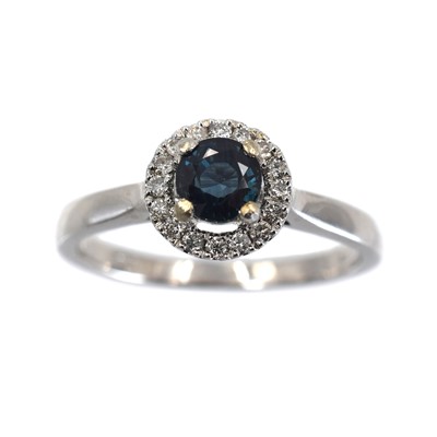 Lot 321 - A sapphire and diamond halo ring, set in 9ct gold