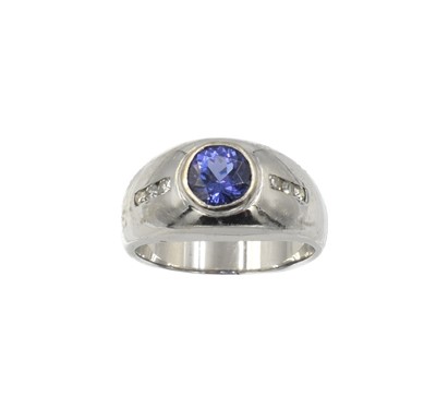Lot 297 - A hefty tanzanite and diamond ring, set in 14ct gold