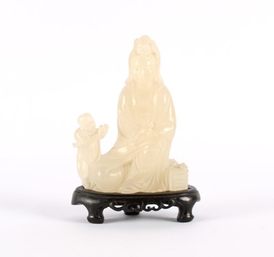 Lot 114 - A Chinese Carved Lychee Stone Guanyin and Shancai Figure Group