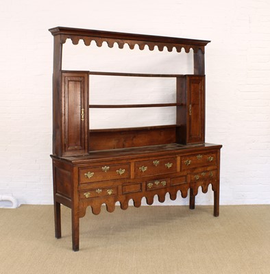 Lot 237 - A George III Oak Dresser with Wavy Cornice and Apron