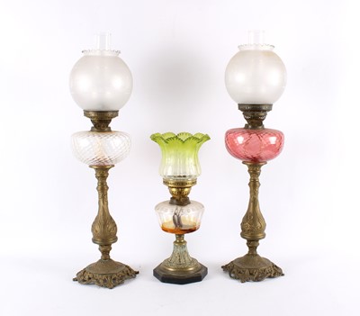 Lot 260 - A Pair of Victorian Brass Oil Lamps with Cranberry and Clear Reservoirs